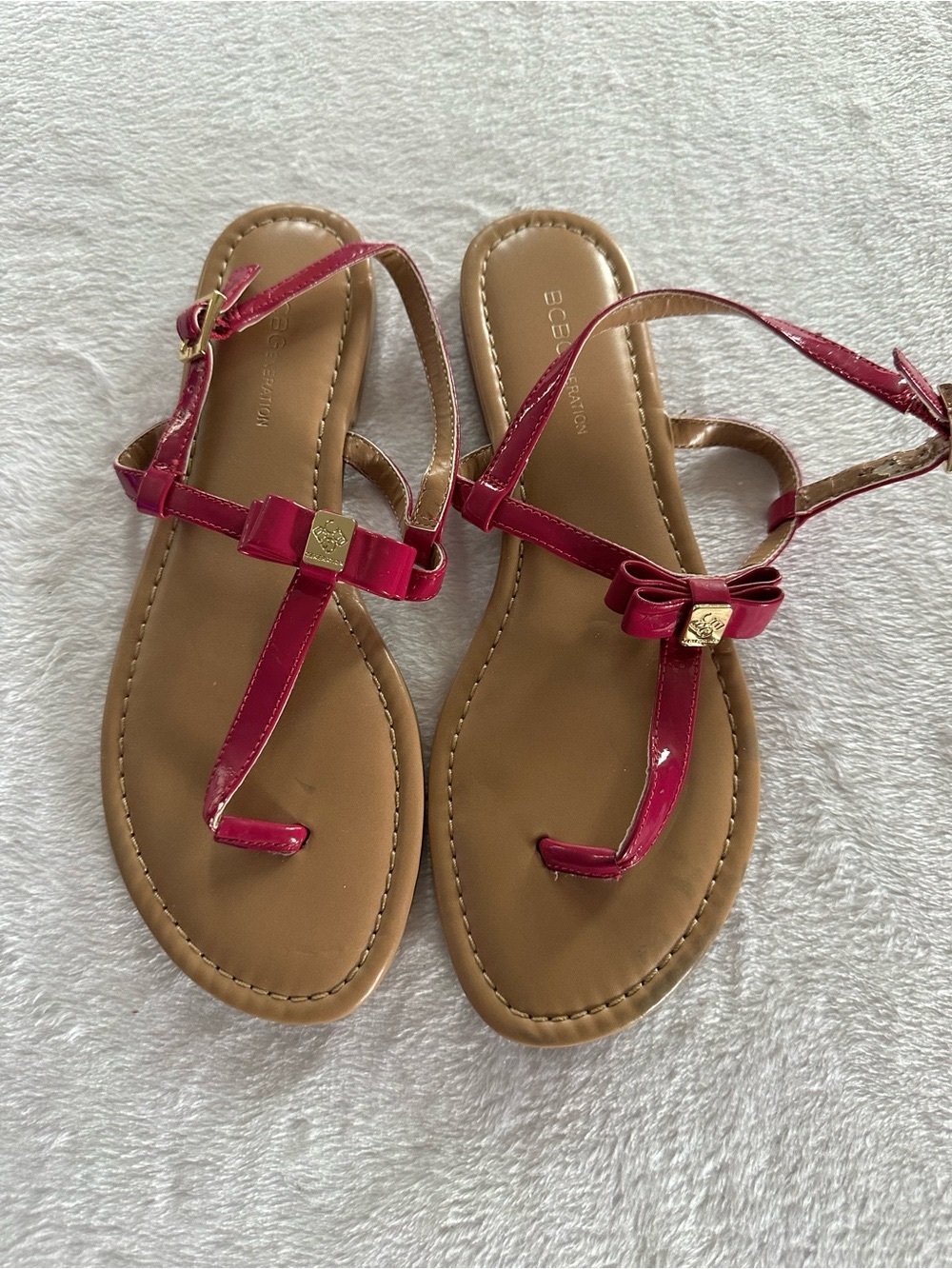 BCBGeneration Patent T-Strap Sandals in Fuchsia with Bow Accent